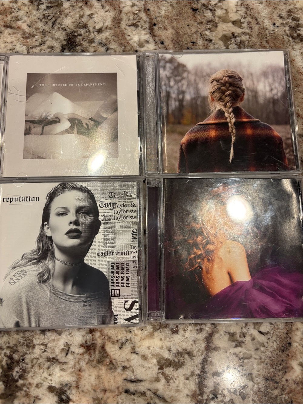 Taylor Swift CDs with Black, White, Purple, Pink Covers